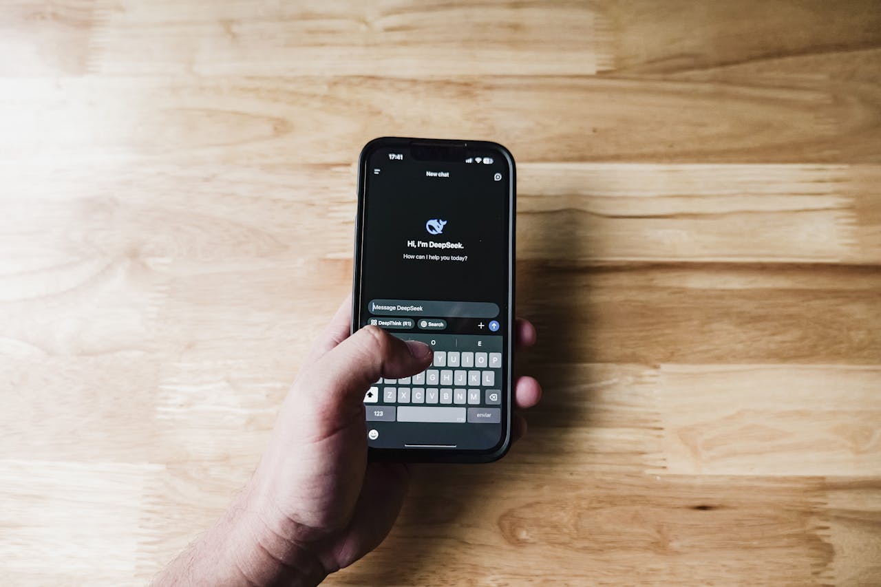 A person interacting with an AI assistant on a smartphone indoors.